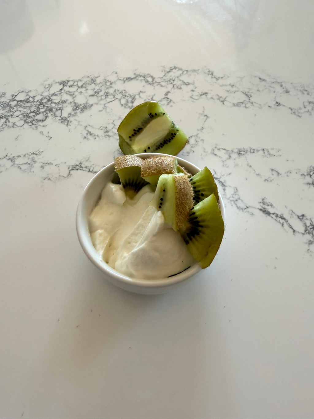 Kiwi slices with the peel on over Greek yogurt